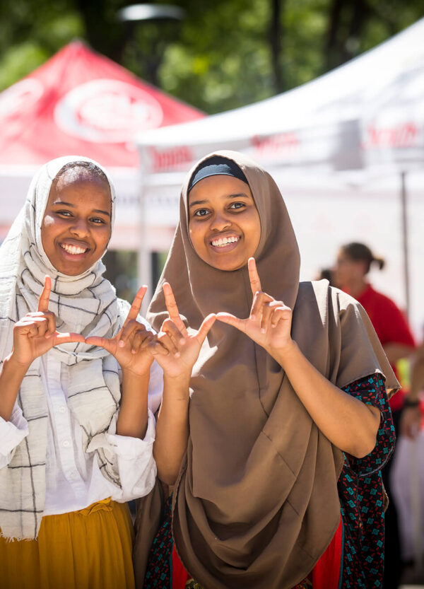 a couple of students doing the U hand sign