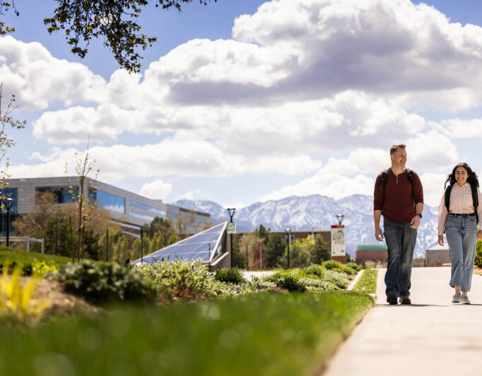 a couple of students walking on campus